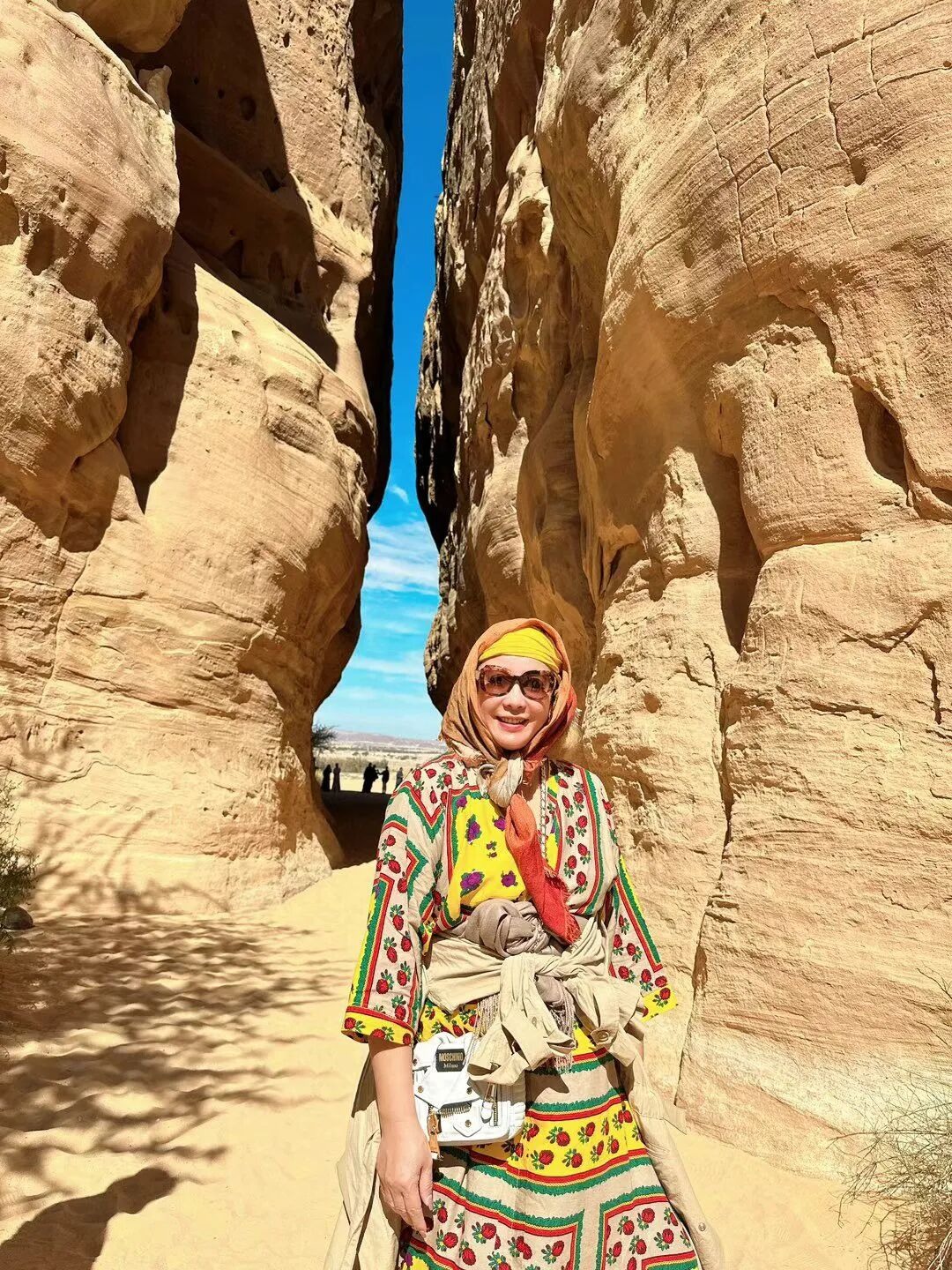 A narrow passage between sandstone walls.