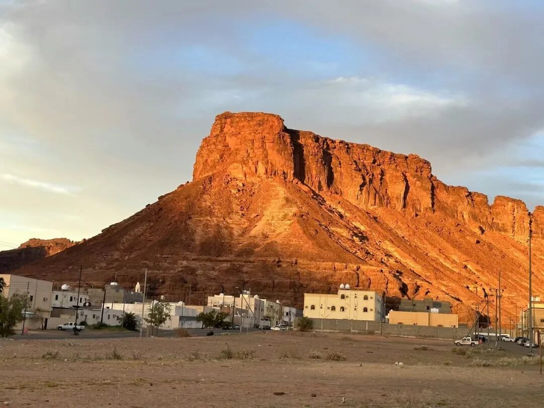 Warm evening light on the sandstone above the town.