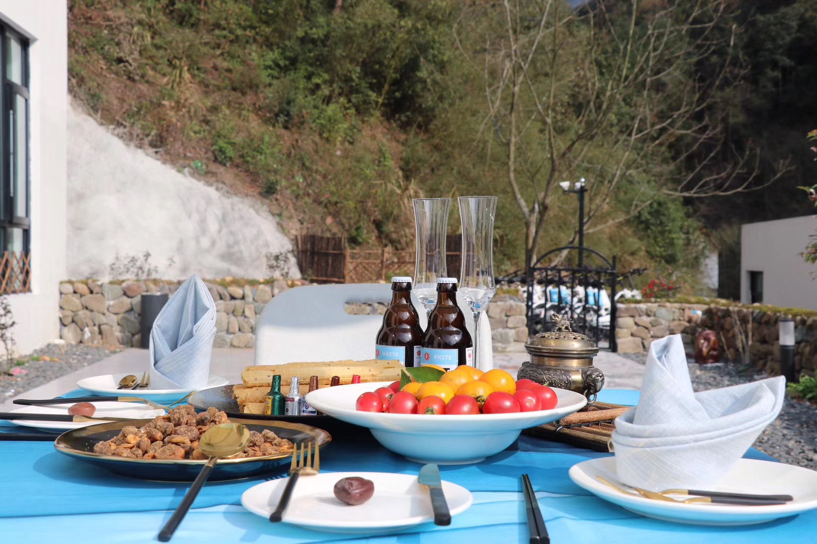 A shared table prepared outdoors.