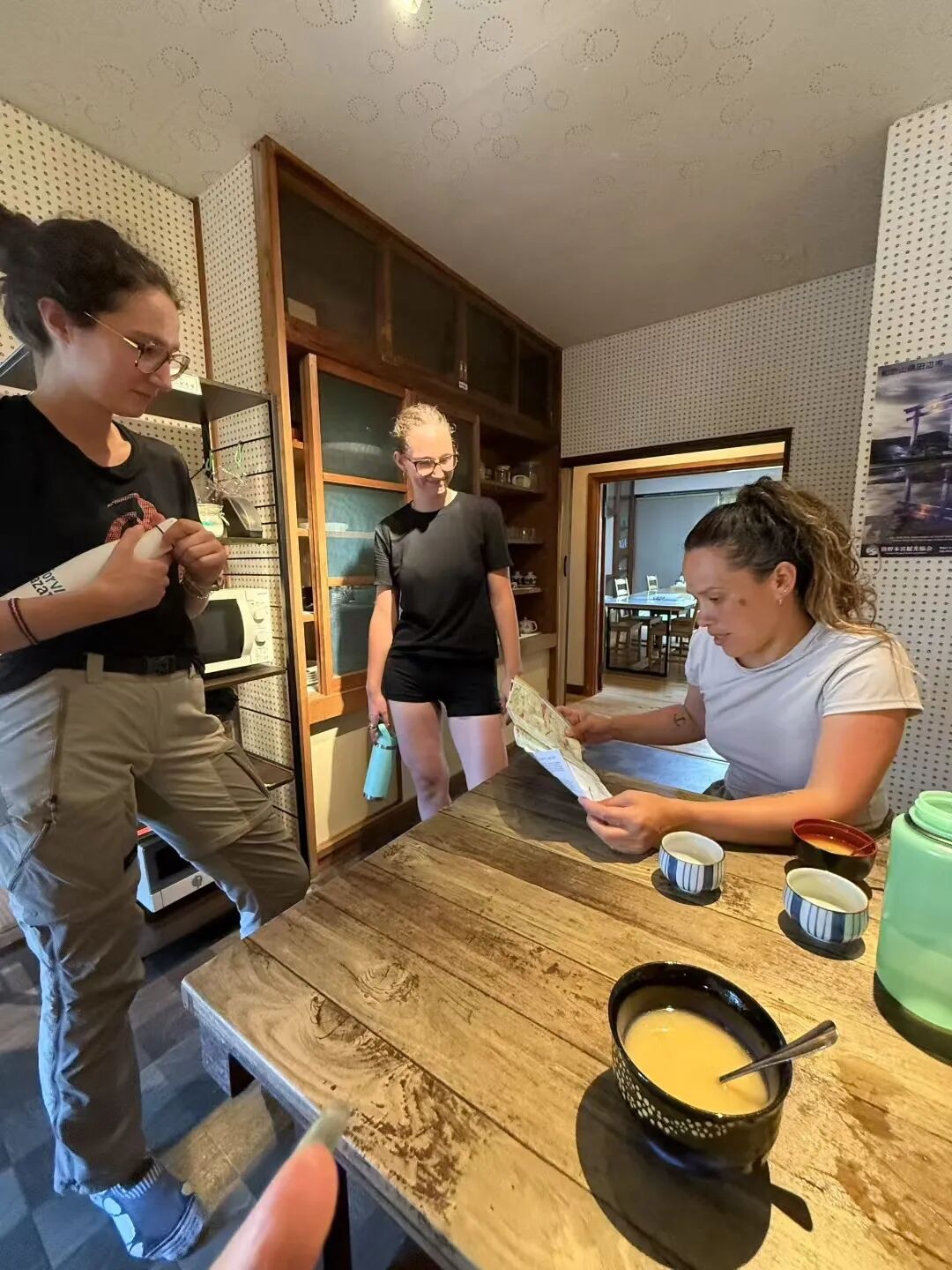 Travellers sharing a table at the hostel.