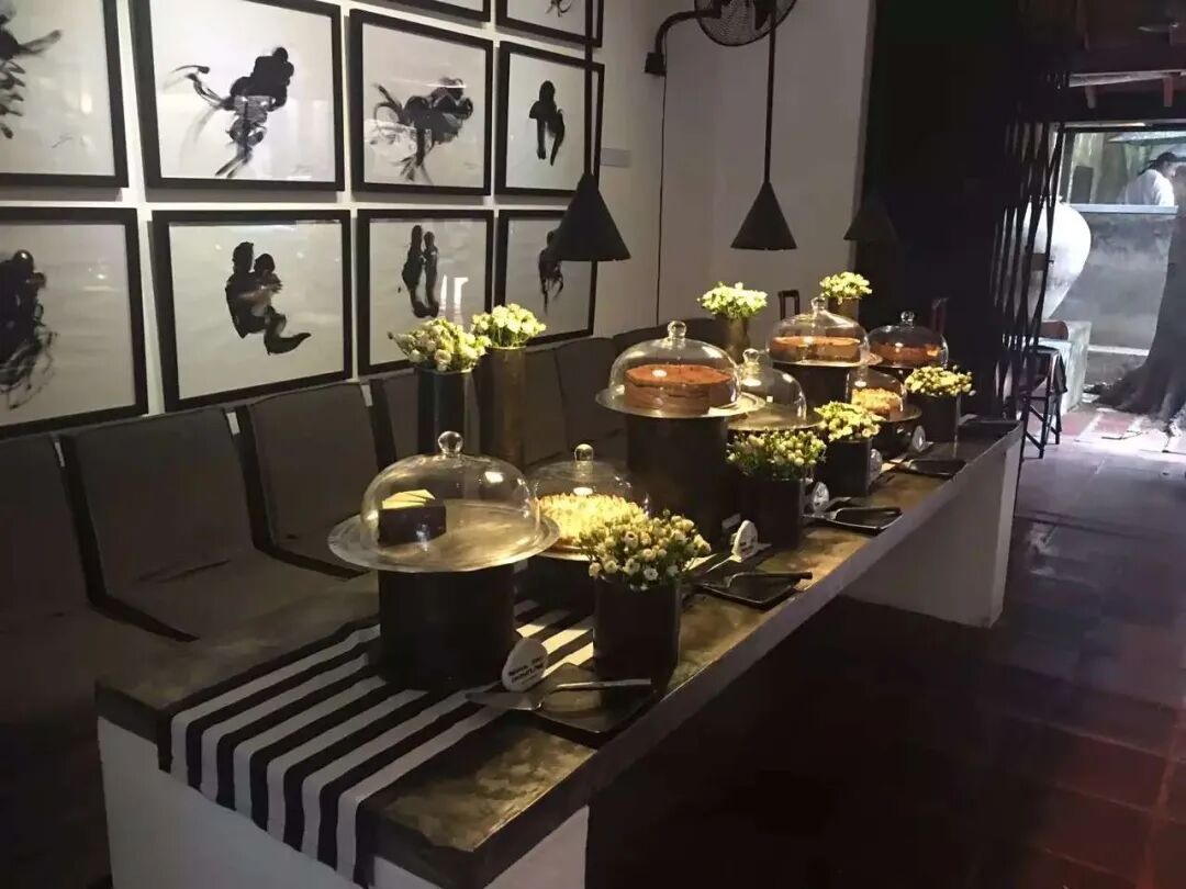 Ceramics and food displayed against a black-and-white setting.
